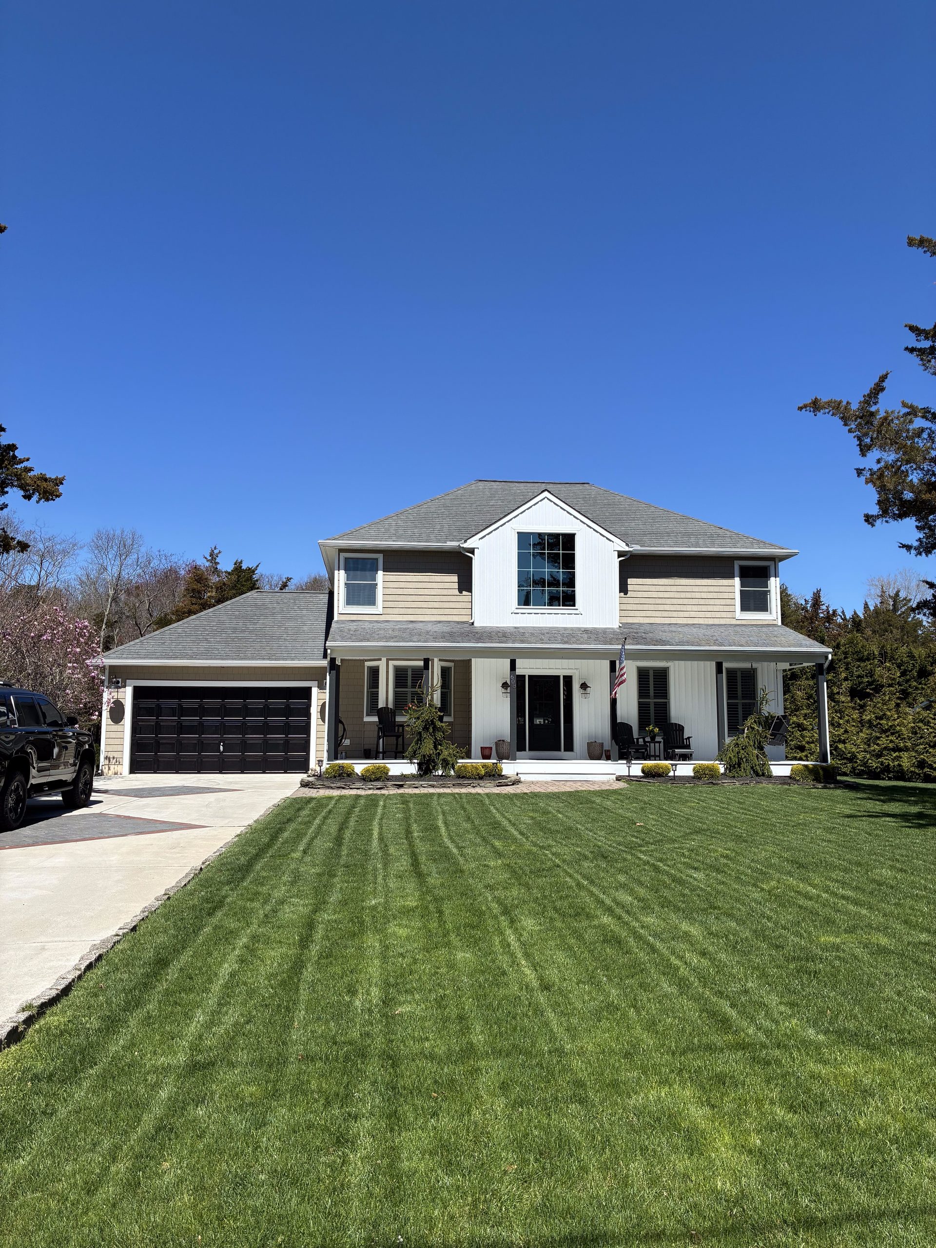 Before and After New Siding and Painted Black Garage Door. — photo 2