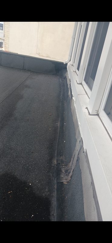 Before and After Pictures Black Granulated Rubber and New Downspouts to take water off of the Roof — photo 1