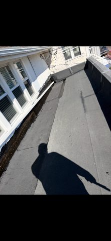 Before and After Pictures Black Granulated Rubber and New Downspouts to take water off of the Roof — photo 3
