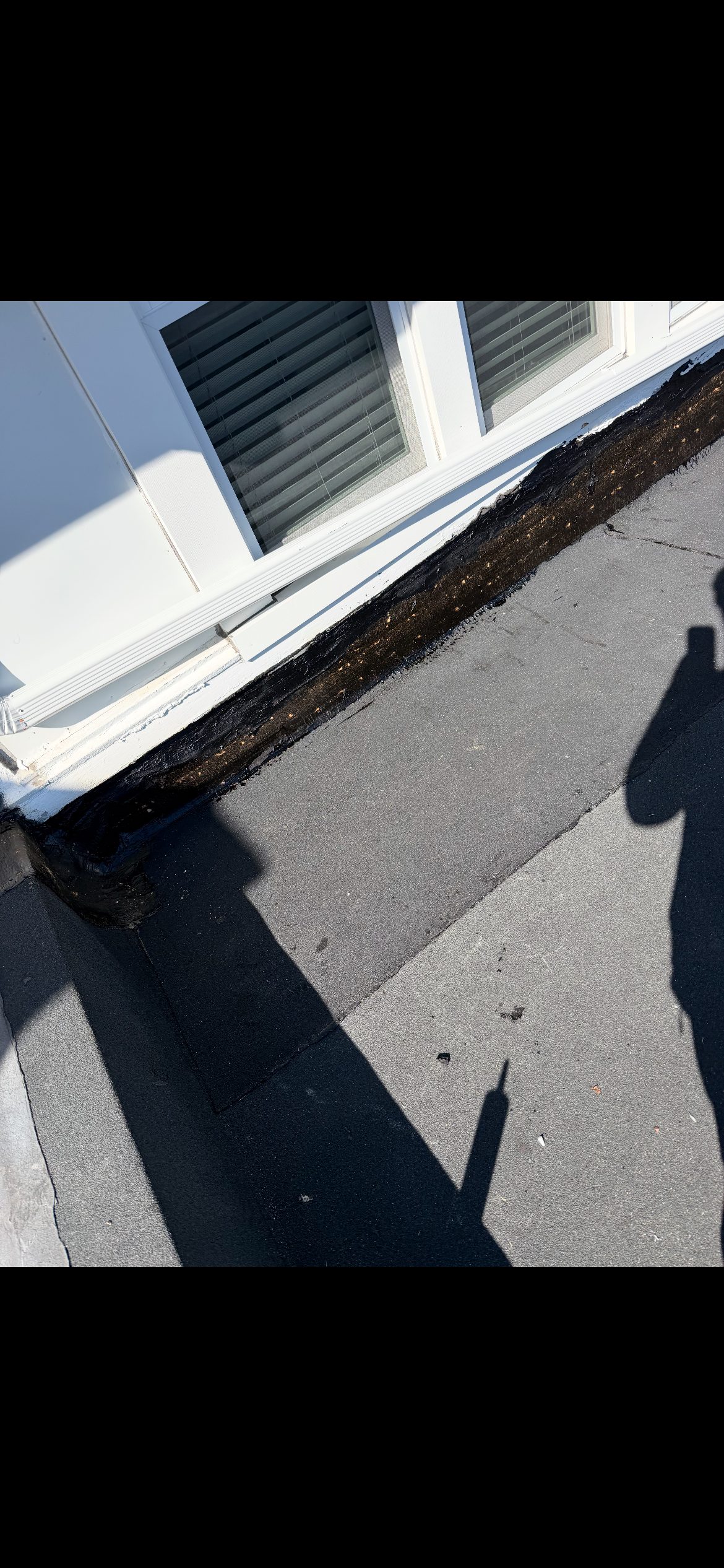 Before and After Pictures Black Granulated Rubber and New Downspouts to take water off of the Roof — photo 5