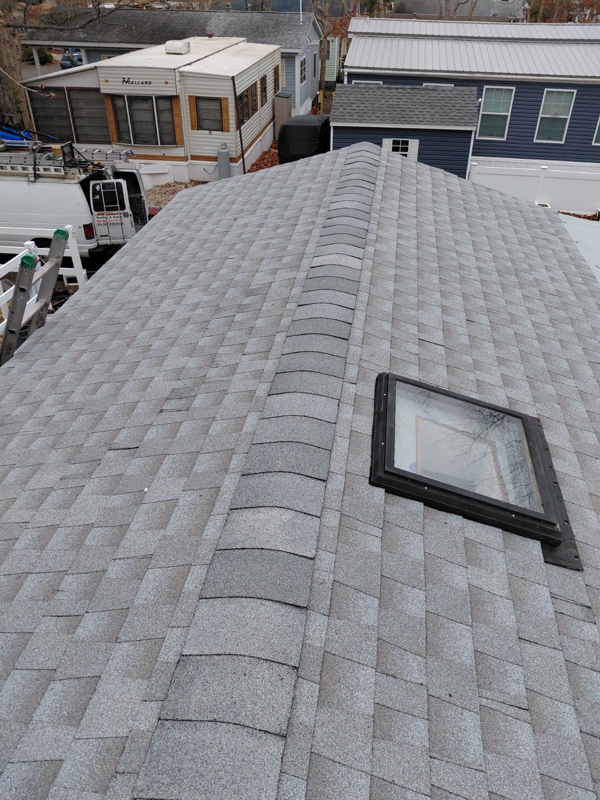 Black-framed skylight installed on a new shingle roof — Be Shore Exteriors